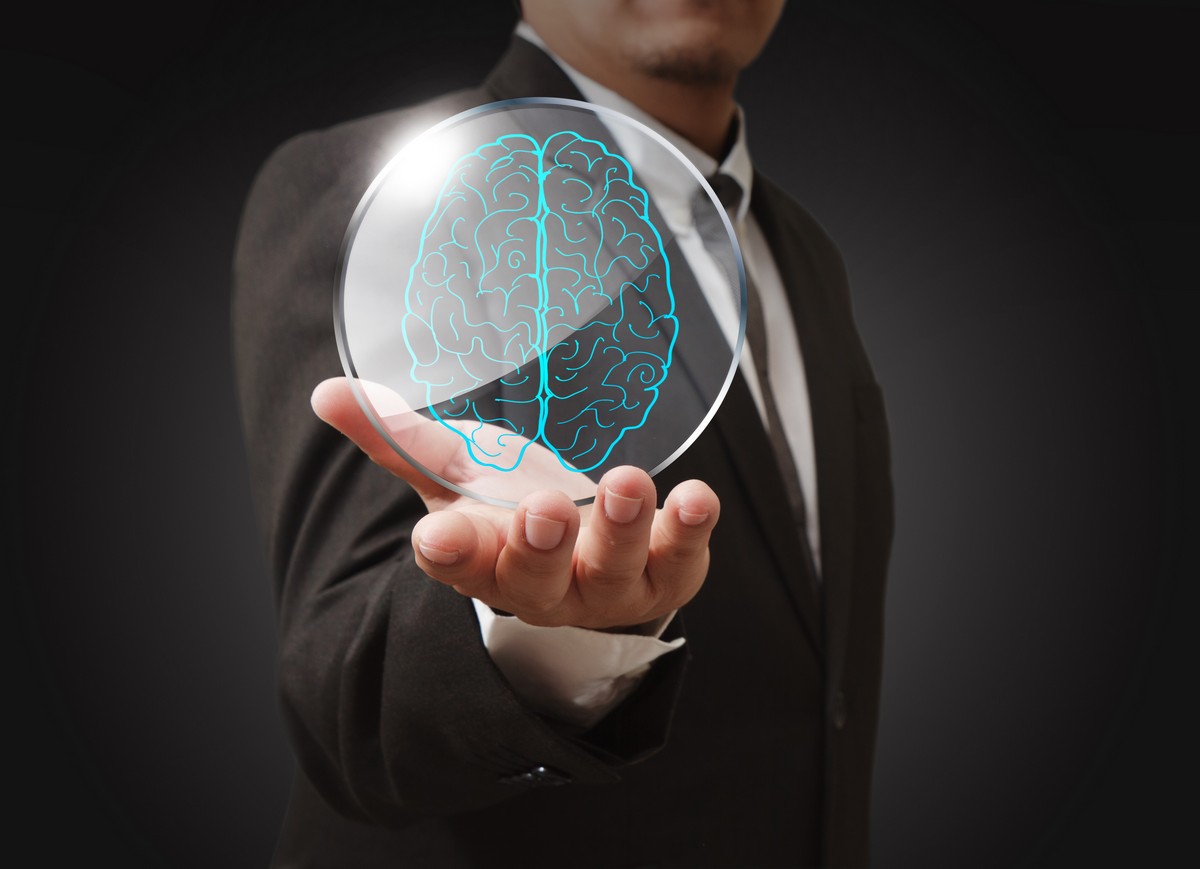 businessman-shows-a-brain-in-shield-glass-as-concept
